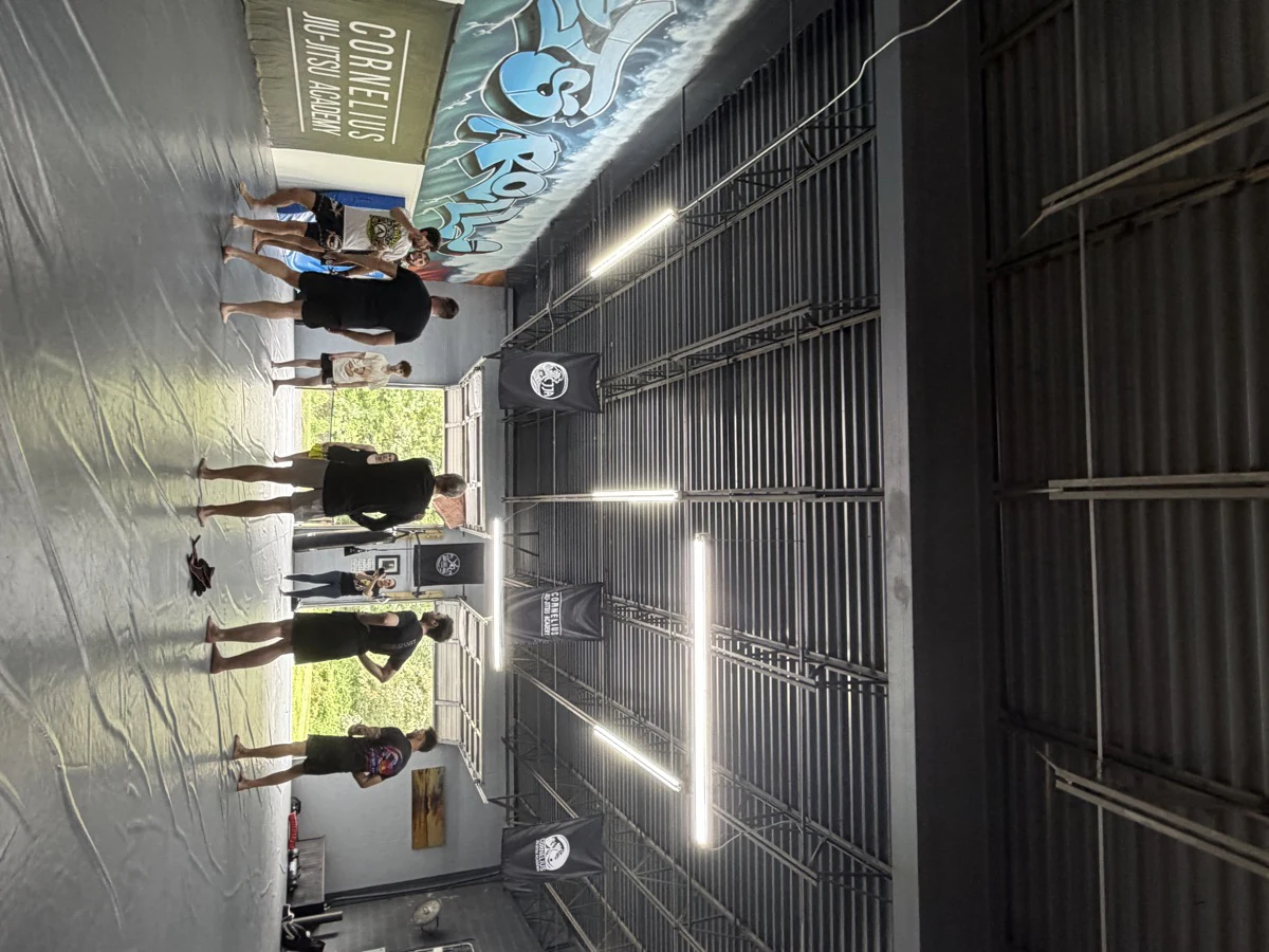Students gathered on the mats beneath the academy banners