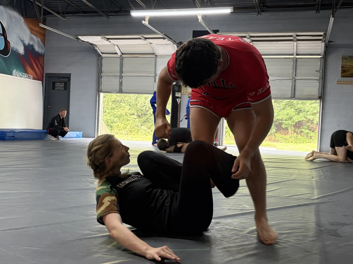 Two no-gi partners working from open guard during a group session
