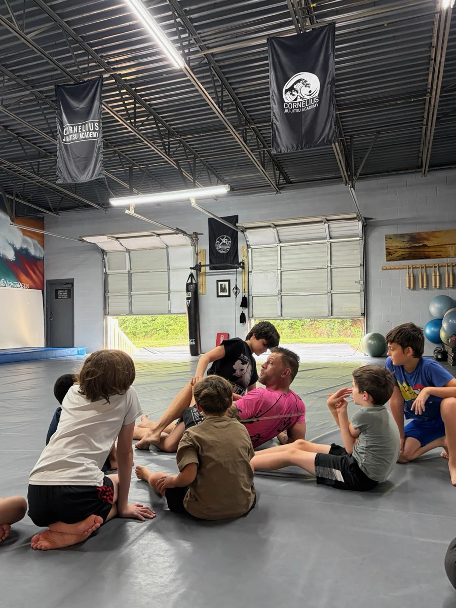 Kids gathered around their coach for a technique demonstration
