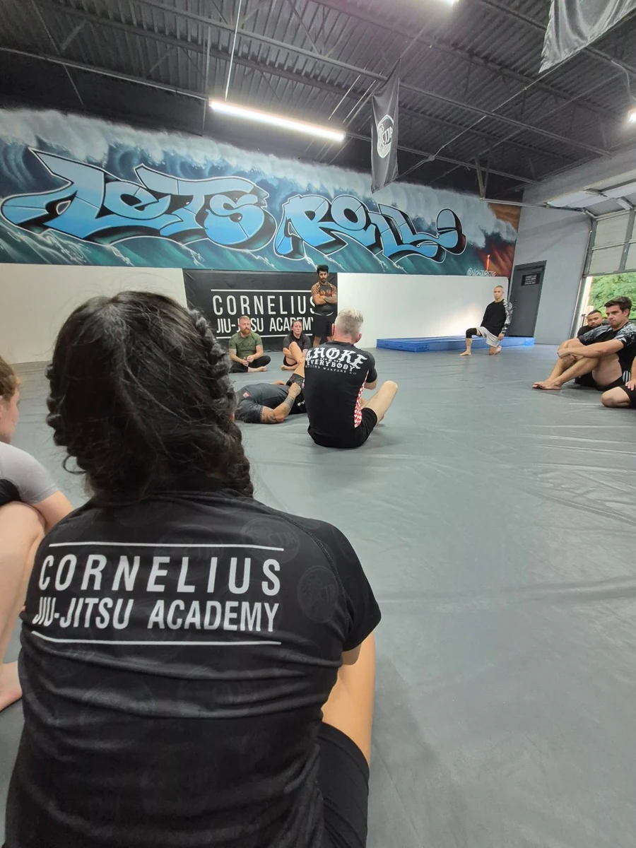 Students gathered around a technique demonstration at CJJA