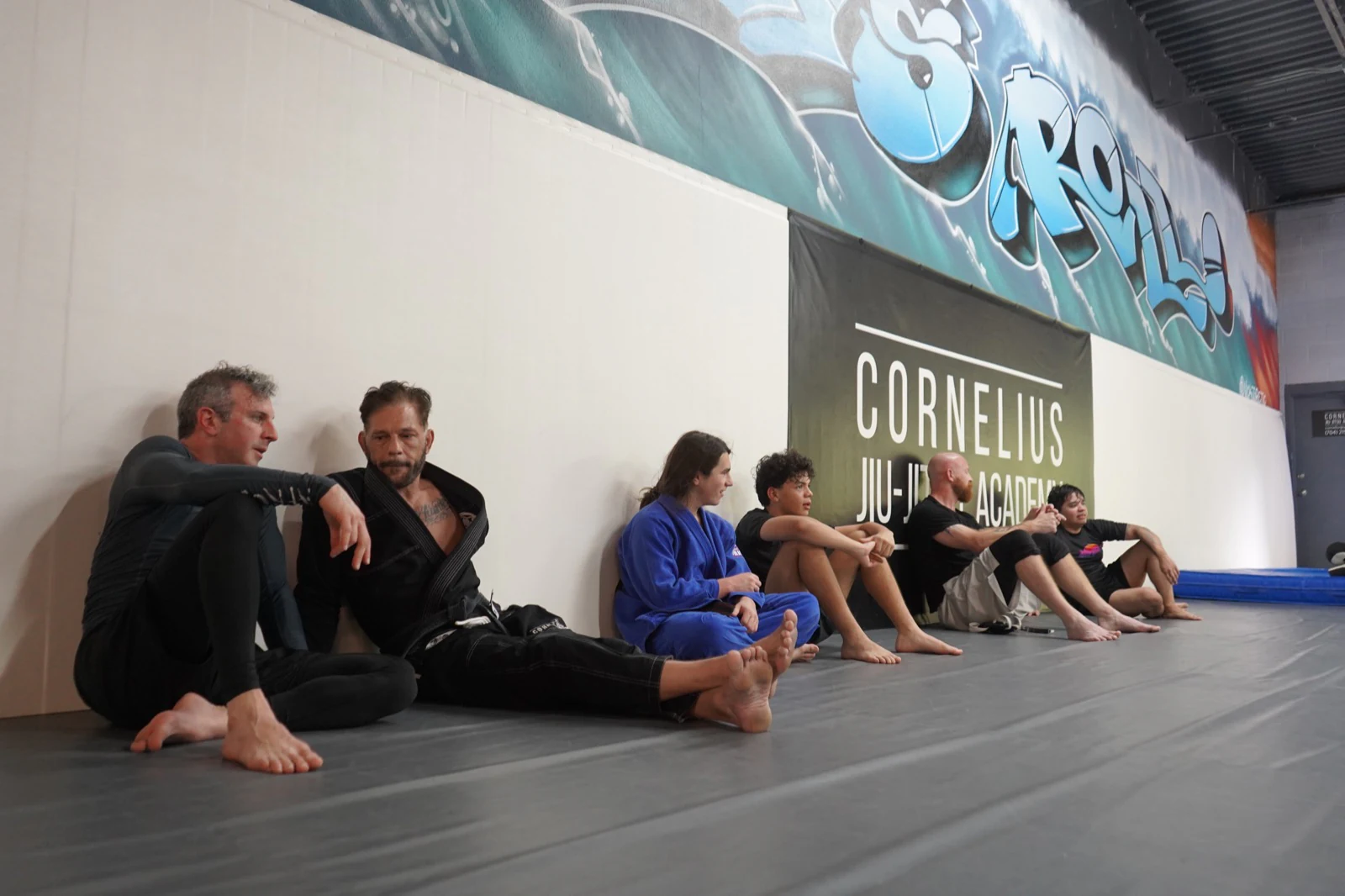 CJJA students relaxing together along the academy wall between rounds